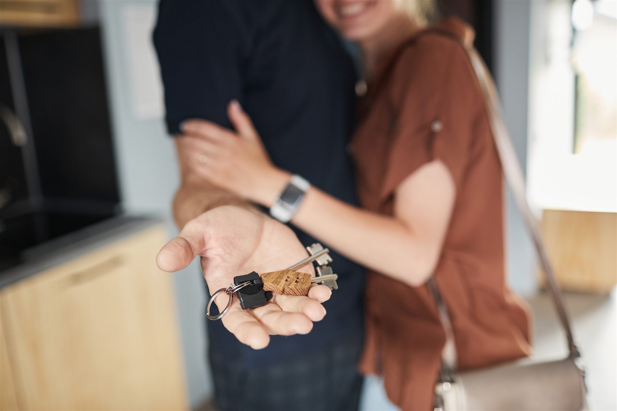 Couple holding keys to their new home