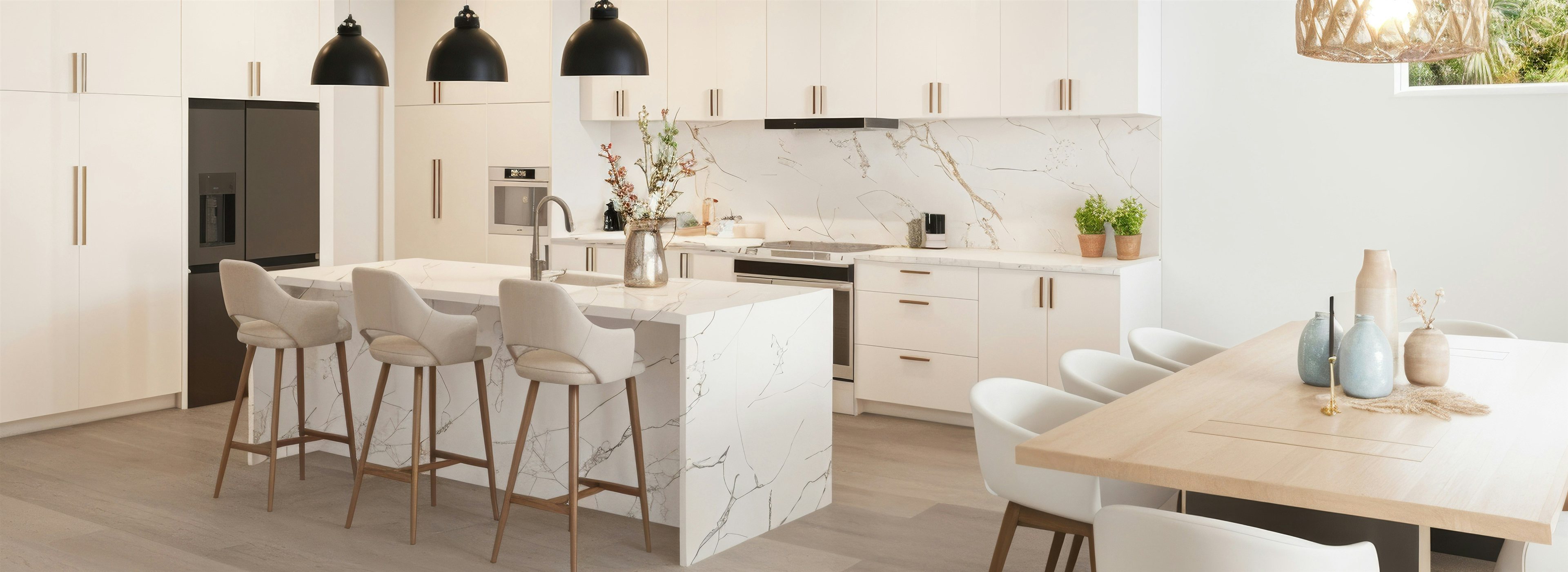 Bright modern kitchen with marble island and black pendant lighting