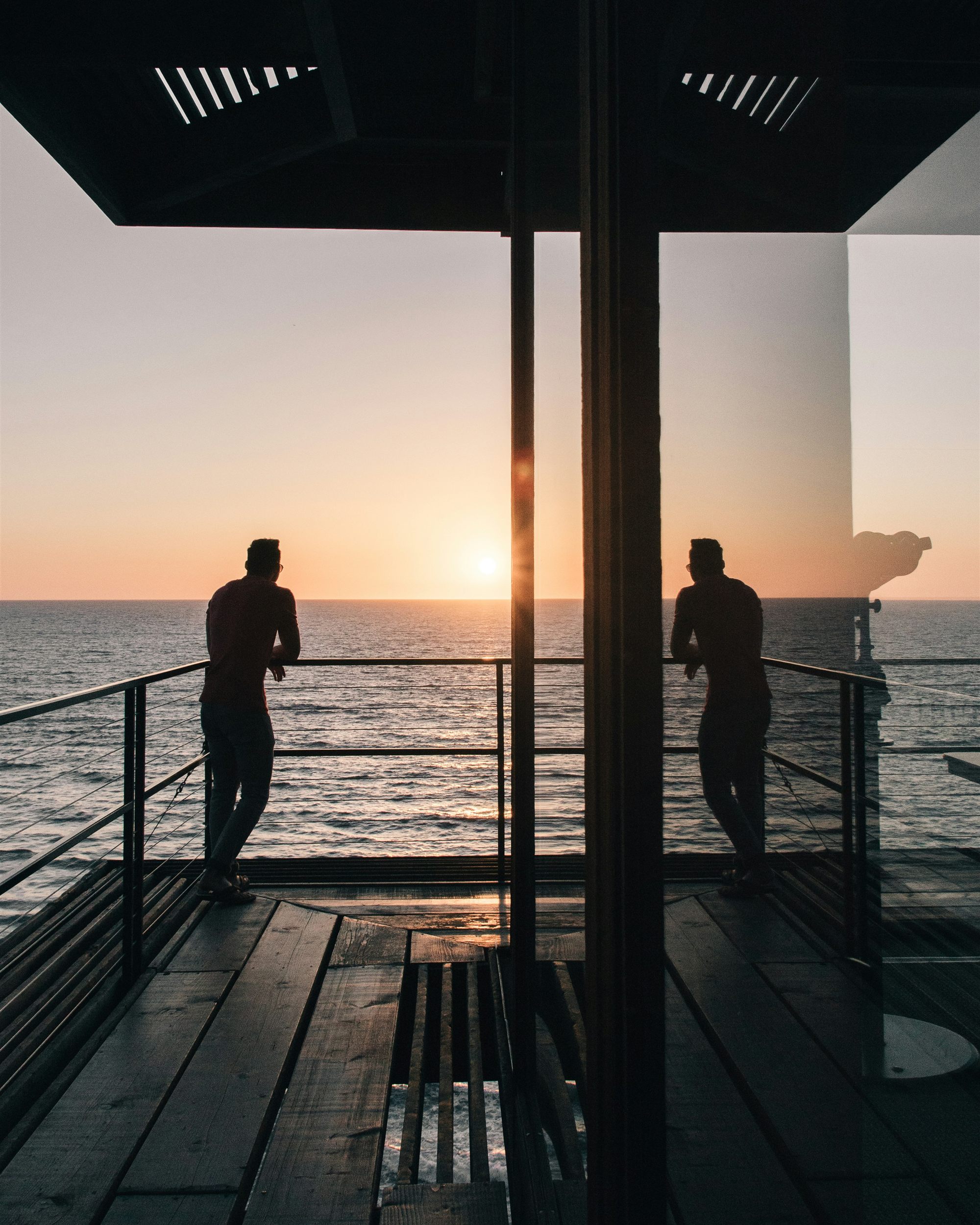 Couple watching the sunset over the water
