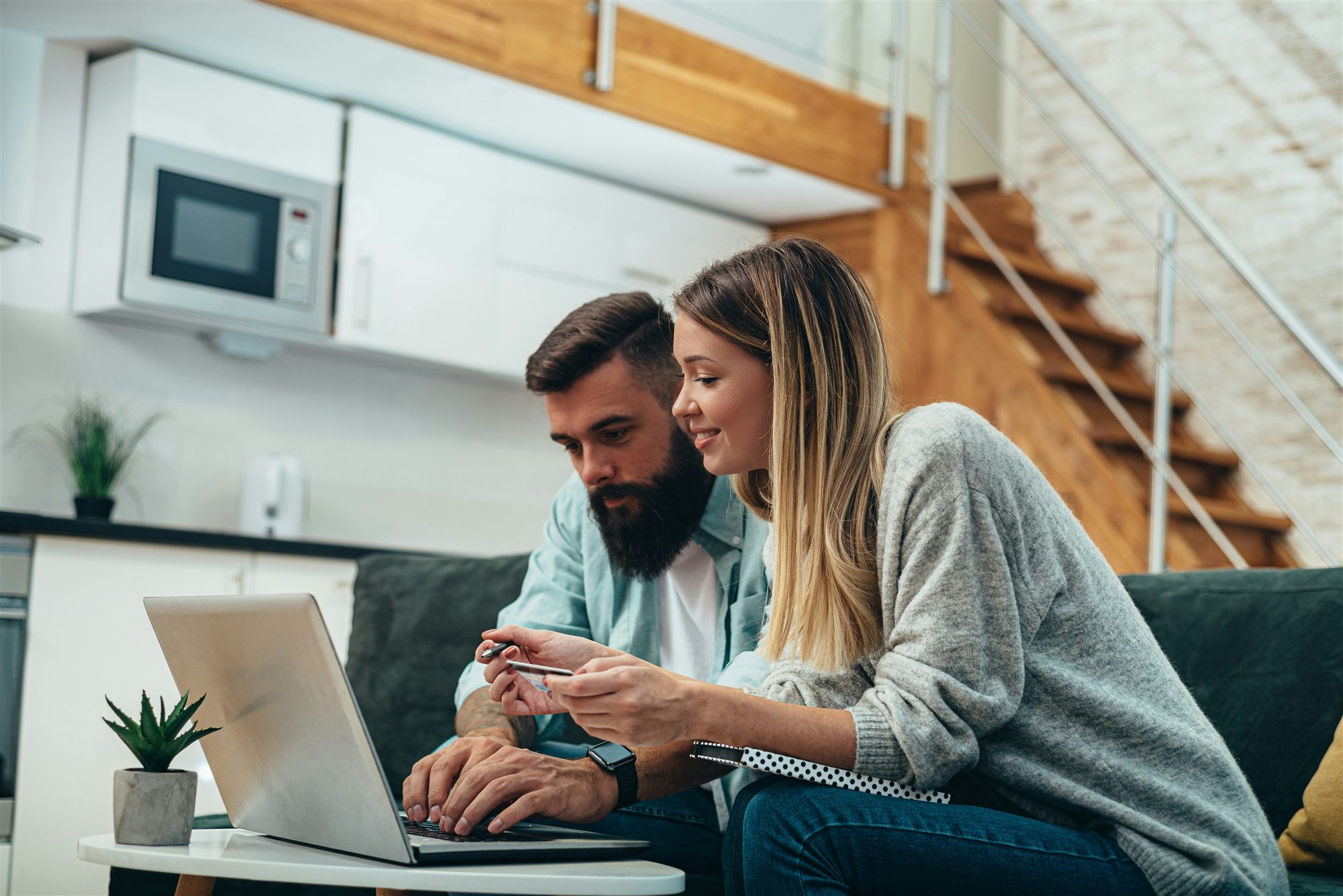 Couple reviewing home search results on a tablet