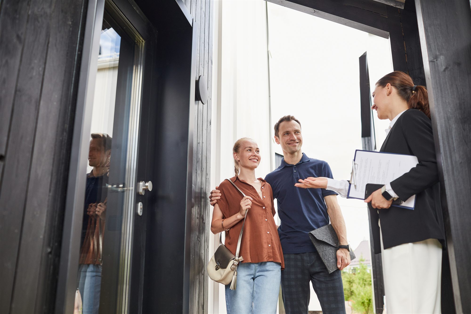 Agent showing a home to a couple
