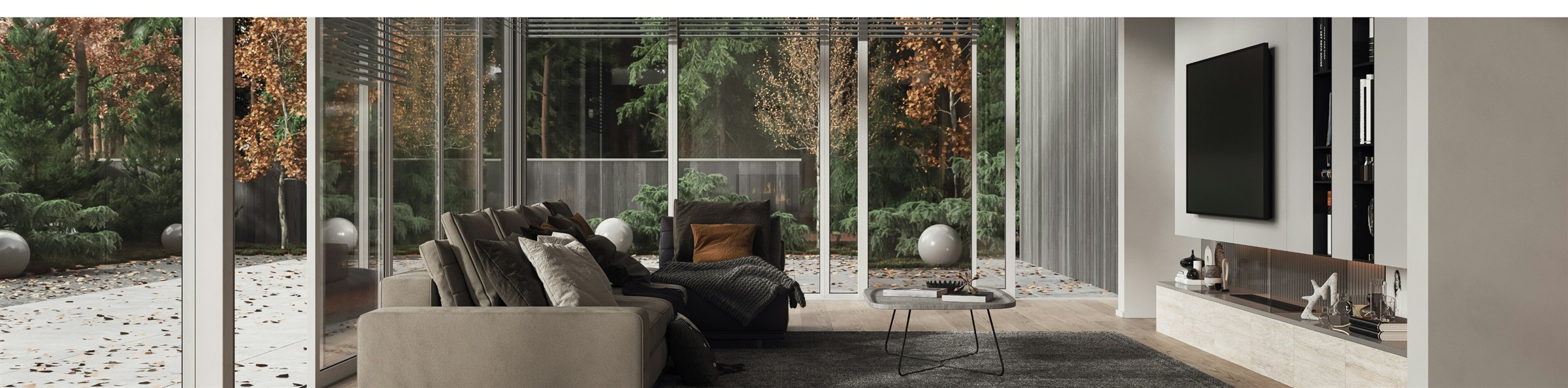 Modern living room with floor-to-ceiling windows overlooking a forest